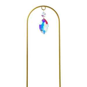 Close-up of garden suncatcher stake with vibrant multi-faceted crystal droplet for plant decor