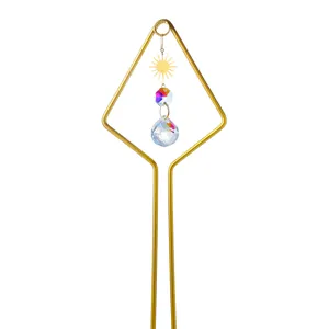 Detail of garden suncatcher stake with sun charm, iridescent bead, and crystal teardrop.