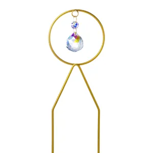 Detailed close-up of a sparkling crystal suncatcher garden stake with rainbow light facets.