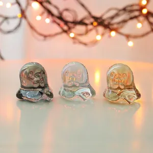 Detailed view of three iridescent crystal ghost figurines for holiday decoration