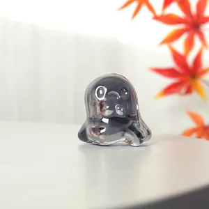 Close-up of a semi-transparent black crystal ghost figurine for Halloween decor