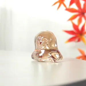 Close-up macro view of a translucent iridescent crystal ghost figurine for Halloween decor