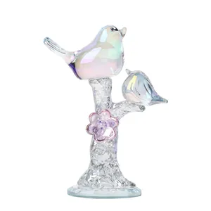 Exquisite detail of iridescent crystal birds perched on a decorative glass tree branch.