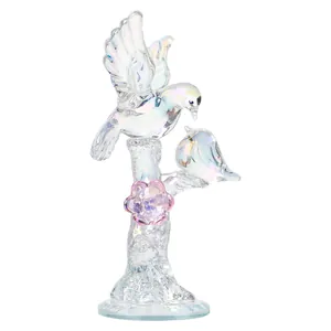 Detail macro view of an iridescent crystal ornament featuring two birds on a branch
