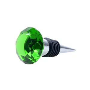 Macro view of a green faceted crystal diamond wine bottle stopper with metal base.
