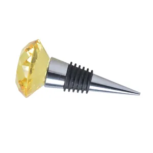 Detailed macro view of a yellow crystal diamond wine bottle stopper with rubber seals.