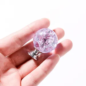 Detailed macro view of a purple ice-crackle crystal ball cabinet knob with a silver base