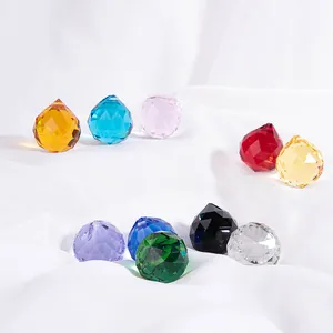 Close-up view of multifaceted crystal glass ball pendants in various vibrant colors