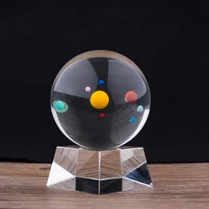 70mm clear crystal ball featuring a solar system inner carving on a faceted glass stand