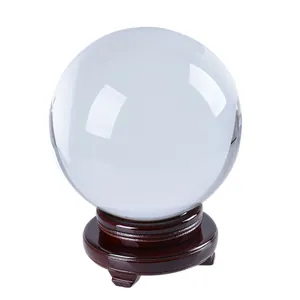 Professional 80mm clear crystal ball for photography and home decor with wooden stand.
