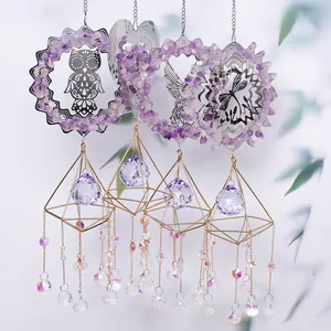 Detail view of purple amethyst suncatchers with metal hummingbird and dragonfly charms