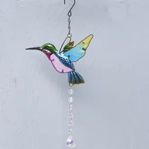 Detailed view of a colorful metal hummingbird suncatcher with crystal bead prism