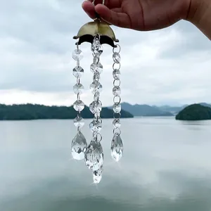 Close-up detail of faceted crystal suncatcher with antique bronze cap in natural light