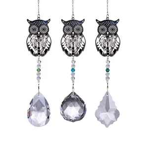 Detailed view of three decorative owl metal charms with assorted crystal prism pendants