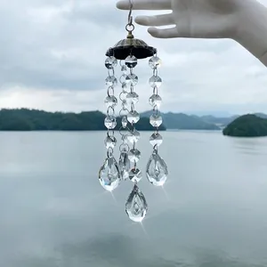 Close-up of sparkling faceted crystal prisms on an antique bronze wind chime pendant