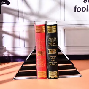 Close-up of elegant crystal staircase bookends holding vintage hardback books in a sunlit room.