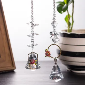 Detailed view of faceted crystal suncatcher pendants with floral metal frames.