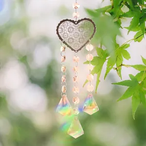 Detail of champagne heart-shaped suncatcher with rainbow crystal prisms.