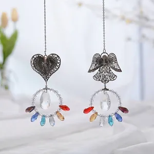 Detailed view of colorful crystal angel and heart filigree suncatchers for home decor.
