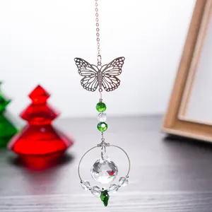 Detail of butterfly crystal suncatcher with green beads and faceted ball