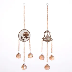 Detail view of elegant champagne crystal hanging ornaments with rose and bell motifs
