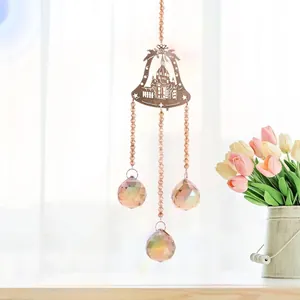 Detailed view of faceted champagne crystal balls on a decorative suncatcher bell pendant
