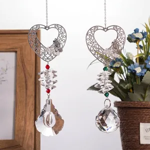 Detailed view of metal heart suncatcher with multi-faceted crystal prisms for home decor