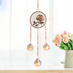 Detail of champagne crystal suncatcher with elegant rose metal mesh and faceted spheres