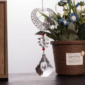 Close-up view of heart-shaped metal pendant with butterfly and faceted crystal beads