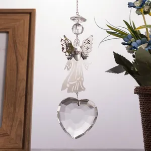 Detailed view of silver metal angel and heart-shaped crystal suncatcher pendant