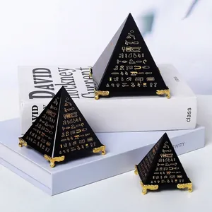 Detail van zwarte piramides met gouden Egyptische hiërogliefen op gouden standaard