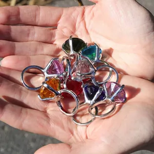 Detailed macro view of colorful faceted crystal diamond rings souvenirs held in hands