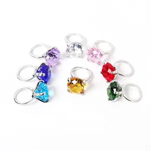 Detailed view of colorful crystal rings arranged in a semi-circle on white