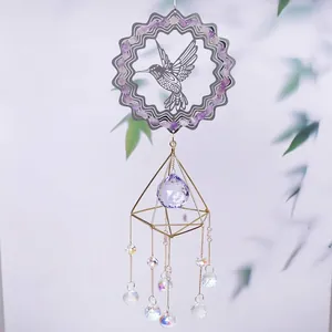 Macro view of a hummingbird suncatcher with purple crystals and gold geometric frame