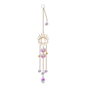 Detail view of evil eye crystal suncatcher with purple stones and iridescent prism pendant.