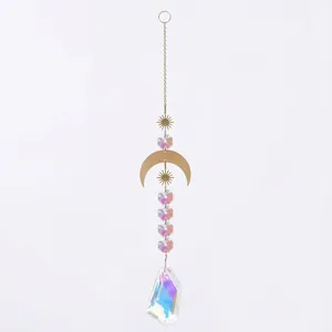 Detailed view of a bohemian iridescent AB crystal suncatcher with golden moon and sun ornaments