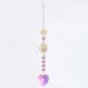 Close-up detail of the sparkling heart-shaped AB crystal pendant on a gold suncatcher