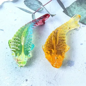 Top view detail of colorful crystal glass fish ornaments with intricate scale texture.