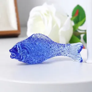 Close-up shot of a decorative vibrant blue crystal fish ornament with textured scales