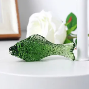 Detailed macro view of a green crystal glass fish figurine with realistic scale texture