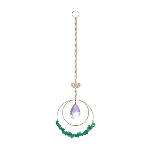 Detail shot of crystal suncatcher with lotus charm and green crushed stones