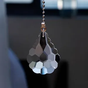 Detailed macro view of a multifaceted teardrop crystal pendant for fan light pulls