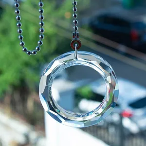 Detailed macro view of a faceted clear crystal circle pendant with a sleek ball chain
