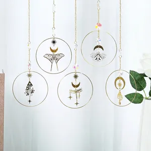 Detailed view of five golden crystal suncatchers featuring moth, dragonfly and mushroom charms