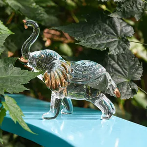 Detailed close-up of a clear crystal elephant figurine with elegant gold accents.