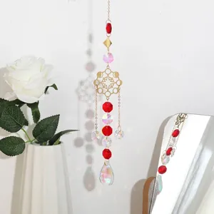 Detailed view of golden snowflake sun catcher with elegant red and iridescent crystal prisms