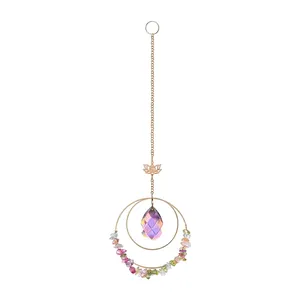 Close-up detail of a purple teardrop crystal suncatcher with gold lotus and stones