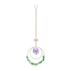 Detailed view of crystal suncatcher with AB heart pendant and green gravel stones