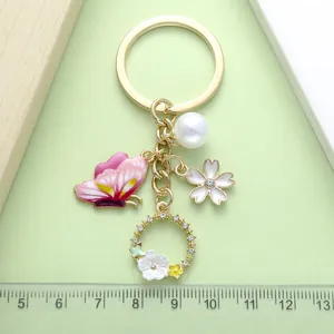 Detailed macro view of pink butterfly and pearl keychain with ruler scale measurement