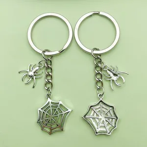 Detail view of silver alloy spider and spiderweb keychains for Halloween bag charms
